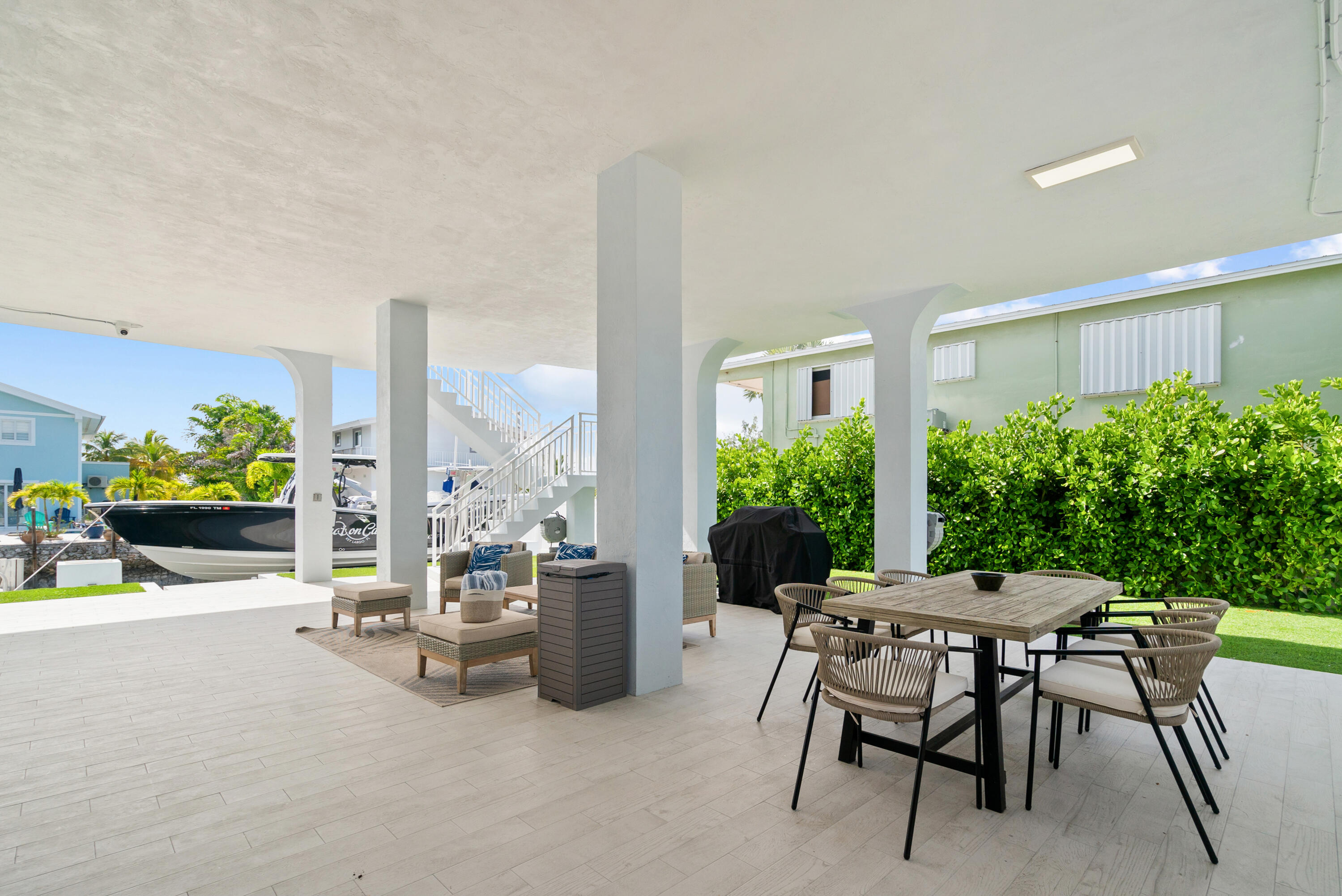 215 Wildwood Circle Key Largo, FL 33037 - Photo 39 of 61 a view of a dining room with furniture and a potted plant