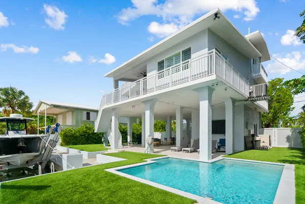 an aerial view of a house with a ocean view