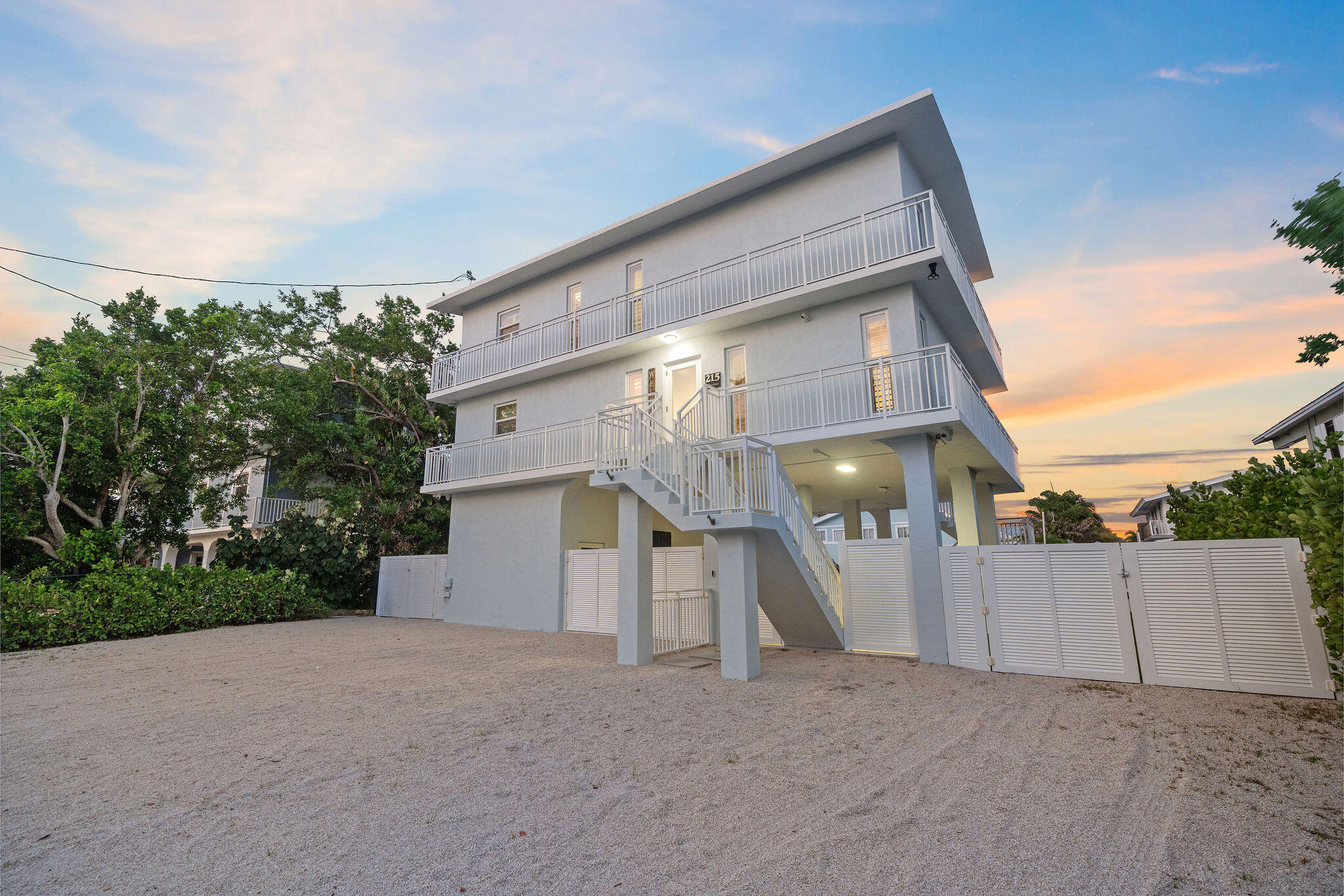 215 Wildwood Circle Key Largo, FL 33037 - Photo 51 of 61 a view of a house with a yard and garage