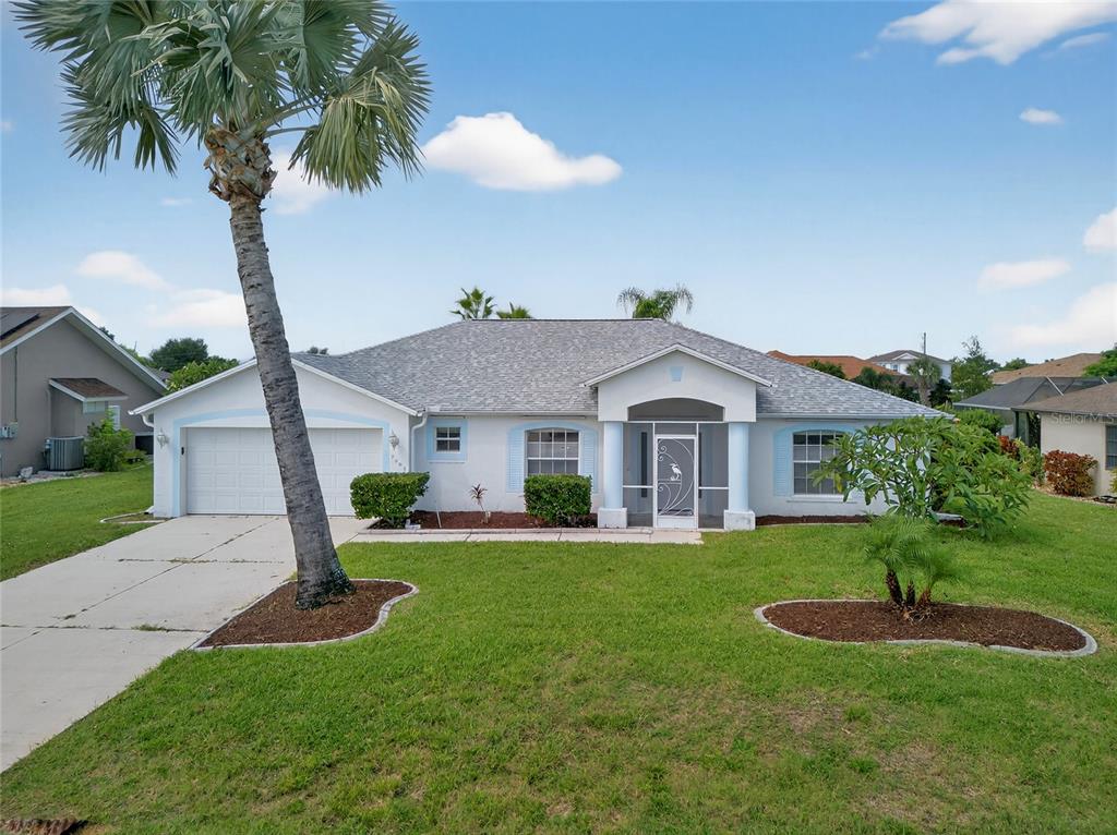a front view of a house with a yard and garage