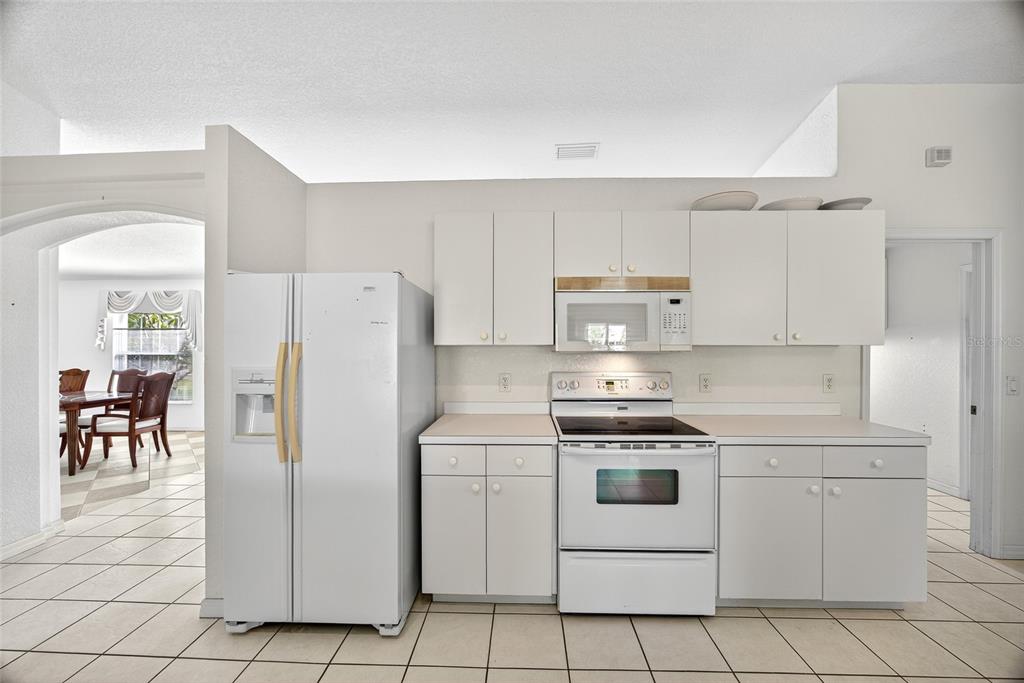 2405 Mauritania Road Punta Gorda, FL 33983 - Photo 12 of 31 a kitchen with white cabinets and white appliances