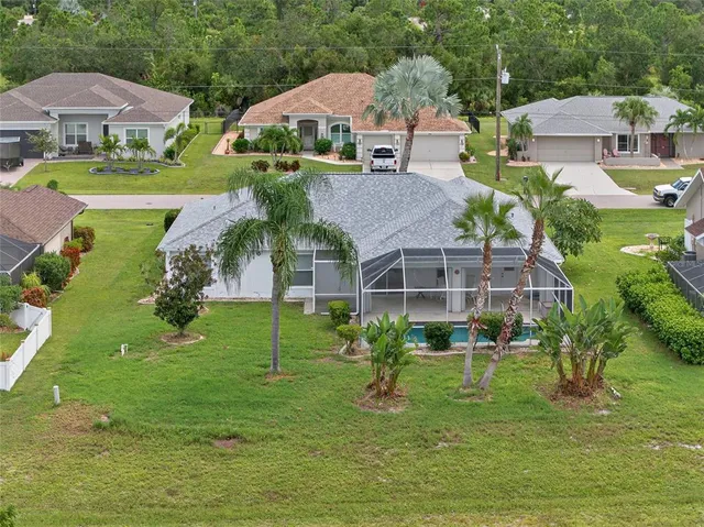 an aerial view of residential houses with outdoor space and street view