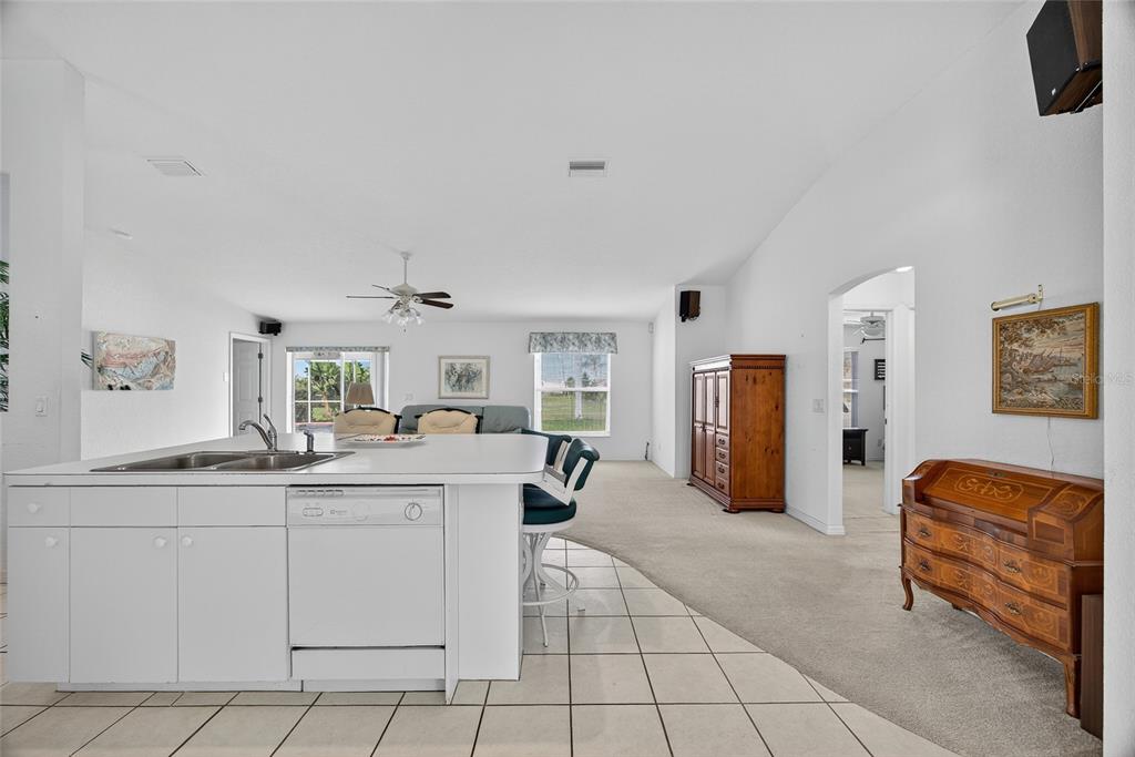 2405 Mauritania Road Punta Gorda, FL 33983 - Photo 6 of 31 a kitchen with stainless steel appliances kitchen island granite countertop a refrigerator and a sink