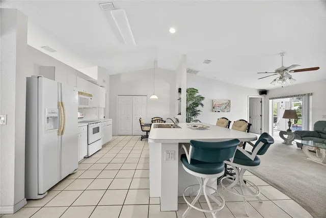 a kitchen with stainless steel appliances kitchen island granite countertop a sink and cabinets