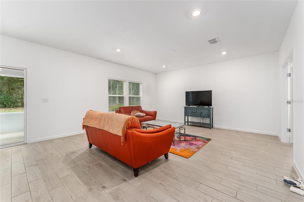 7755 Southwest 74th Loop Ocala, FL 34481 - Photo 16 of 66 a living room with furniture and a flat screen tv