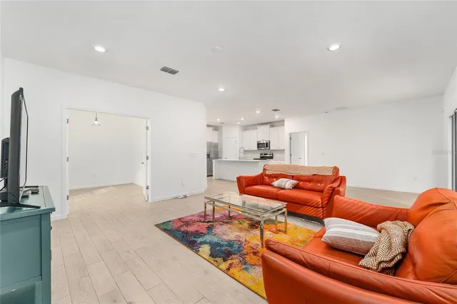 an empty room with a window and a wooden floor