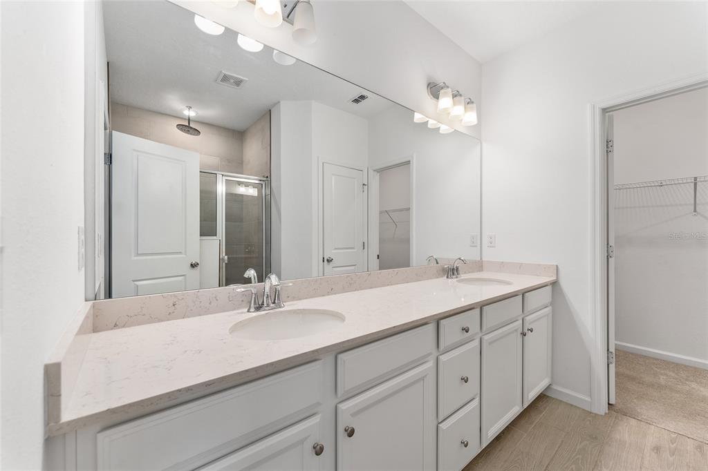 7755 Southwest 74th Loop Ocala, FL 34481 - Photo 28 of 66 a bathroom with a sink double vanity and a mirror