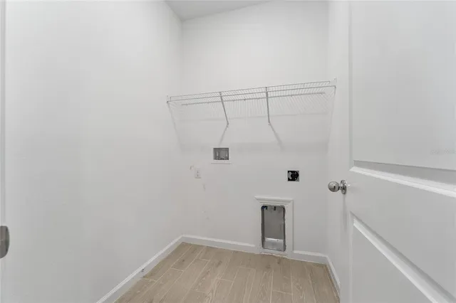 a view of an empty room and window ceiling fan