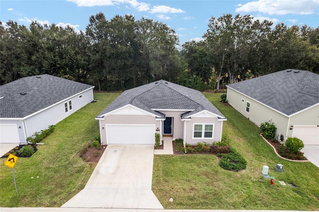 7755 Southwest 74th Loop Ocala, FL 34481 - Photo 4 of 66 a aerial view of a house with a yard and large trees