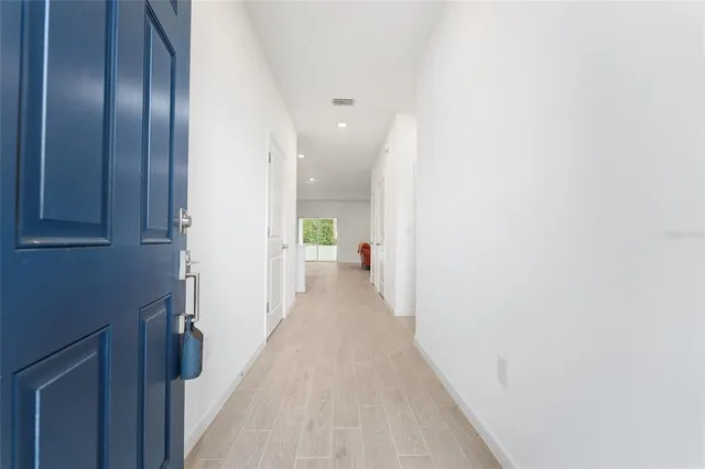 a view of a hallway with wooden floor