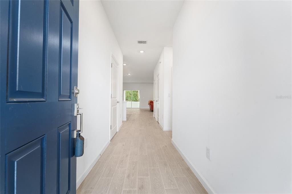 7755 Southwest 74th Loop Ocala, FL 34481 - Photo 6 of 66 a view of a hallway with wooden floor