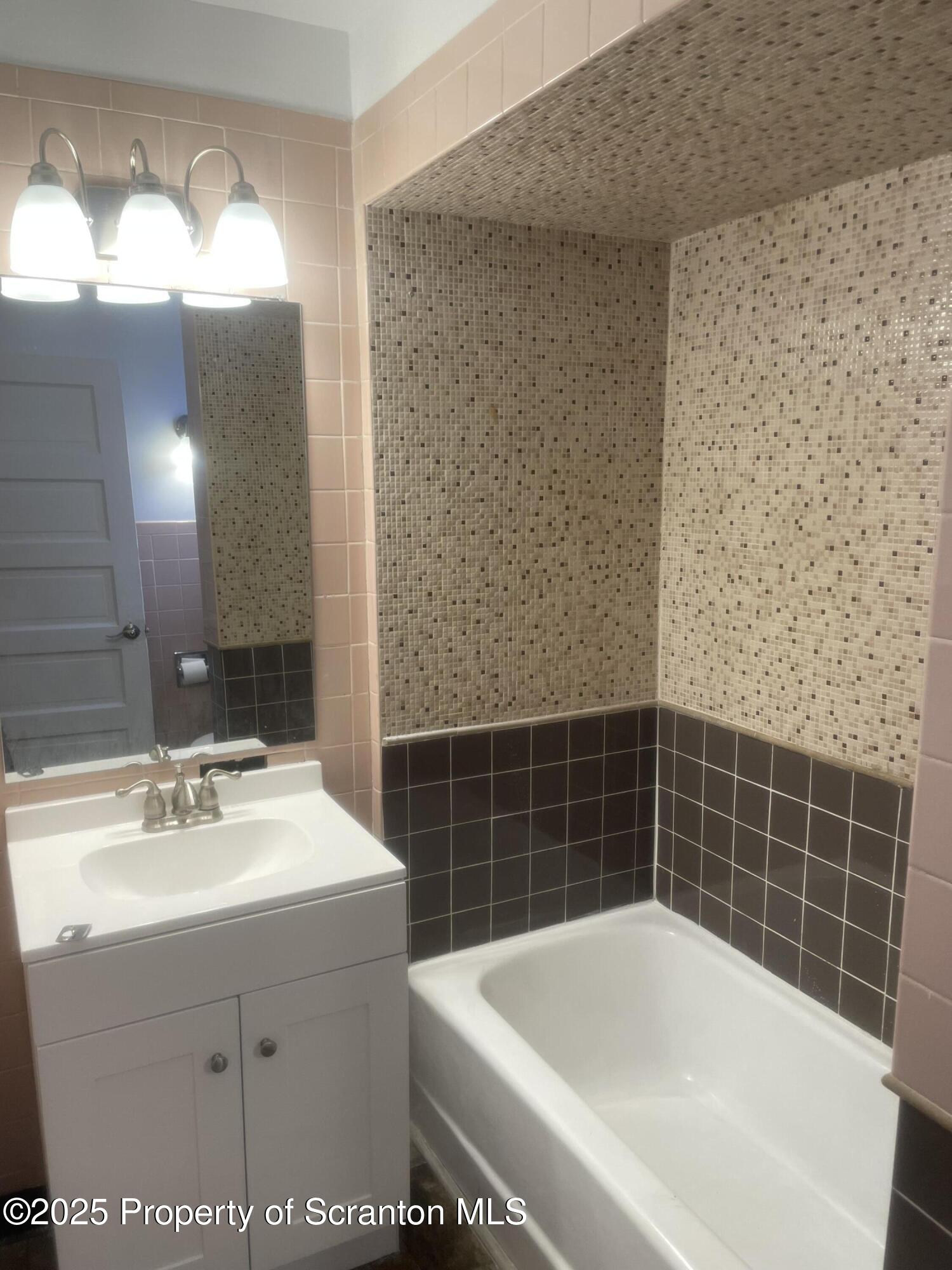 2301 Boulevard Avenue Scranton, PA 18509 - Photo 17 of 25 a bathroom with a sink mirror and a bathtub