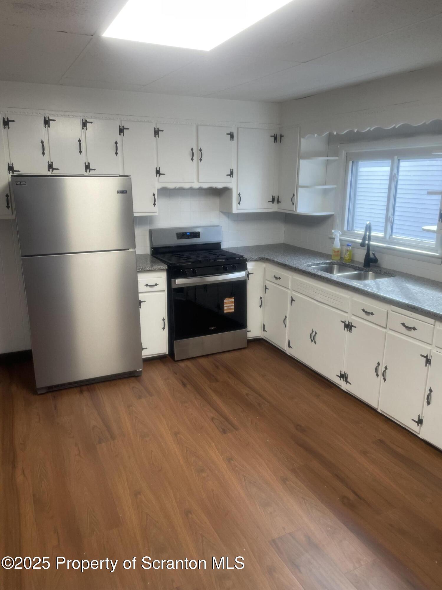 2301 Boulevard Avenue Scranton, PA 18509 - Photo 3 of 25 a kitchen with granite countertop white cabinets and white appliances