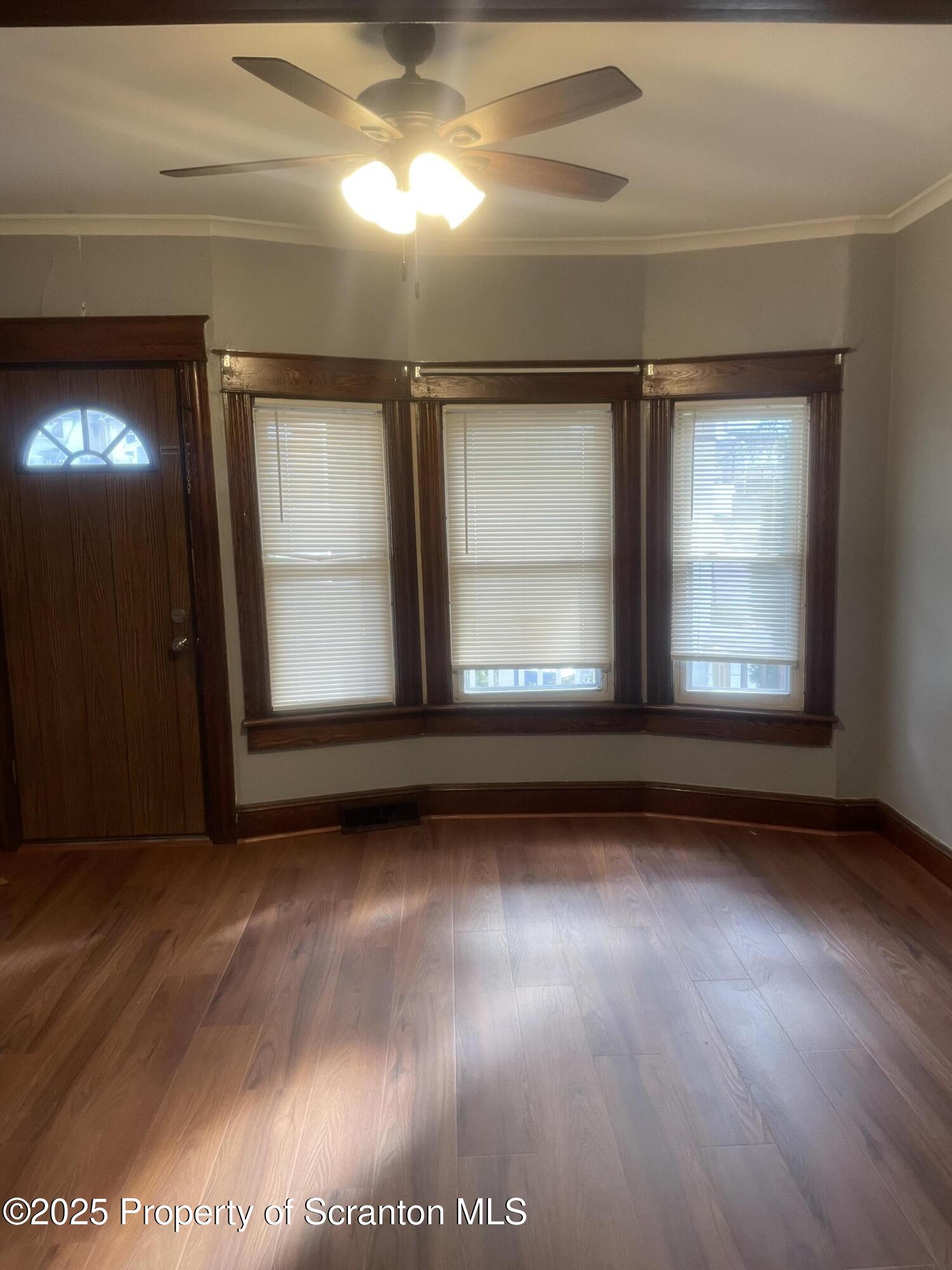 2301 Boulevard Avenue Scranton, PA 18509 - Photo 8 of 25 a view of an empty room with wooden floor and a window