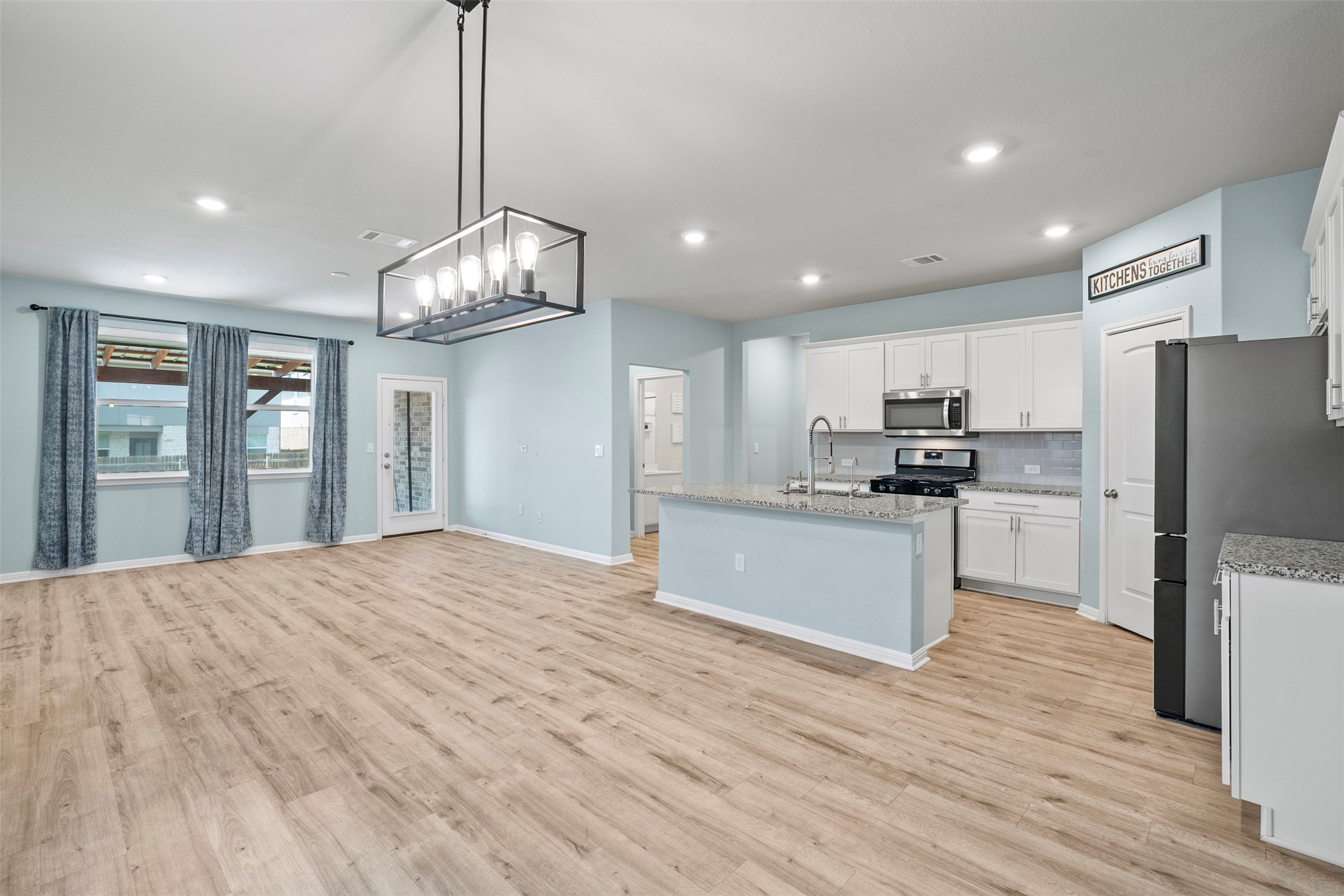 120 Ellinger Road Georgetown, TX 78626 - Photo 3 of 28 Open-concept living space with wood-finish flooring throughout