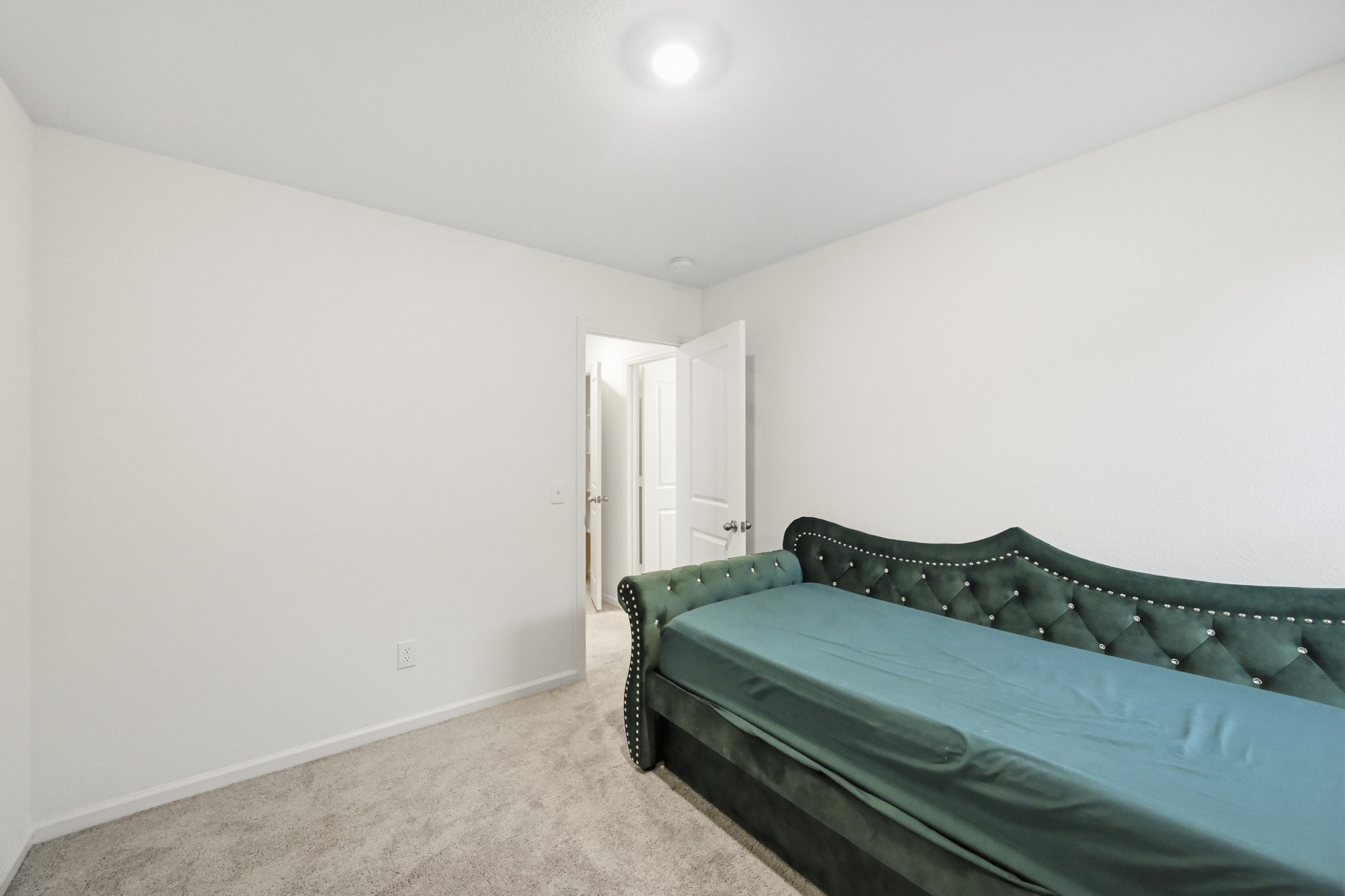 7207 Evitale Way Houston, TX 77049 - Photo 26 of 43 a bedroom with a bed and a lamp on the dresser