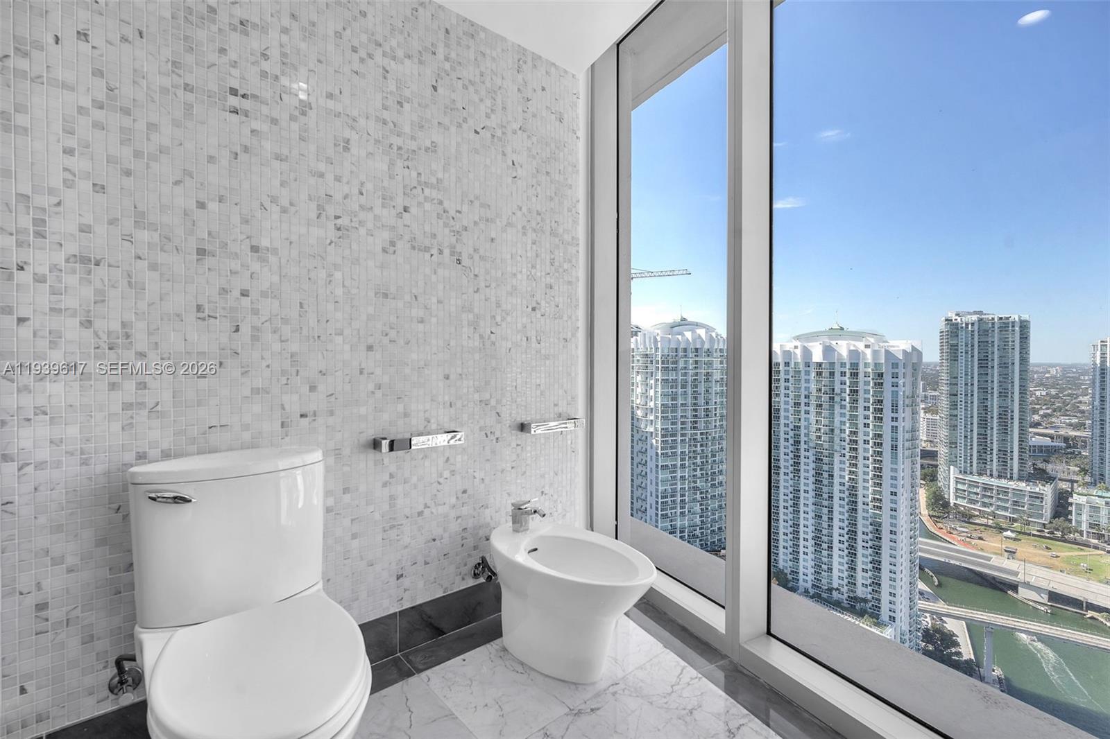200 Biscayne Blvd Way, Unit 4202 Miami, FL 33131 - Photo 16 of 31 a bathroom with a toilet and a shower