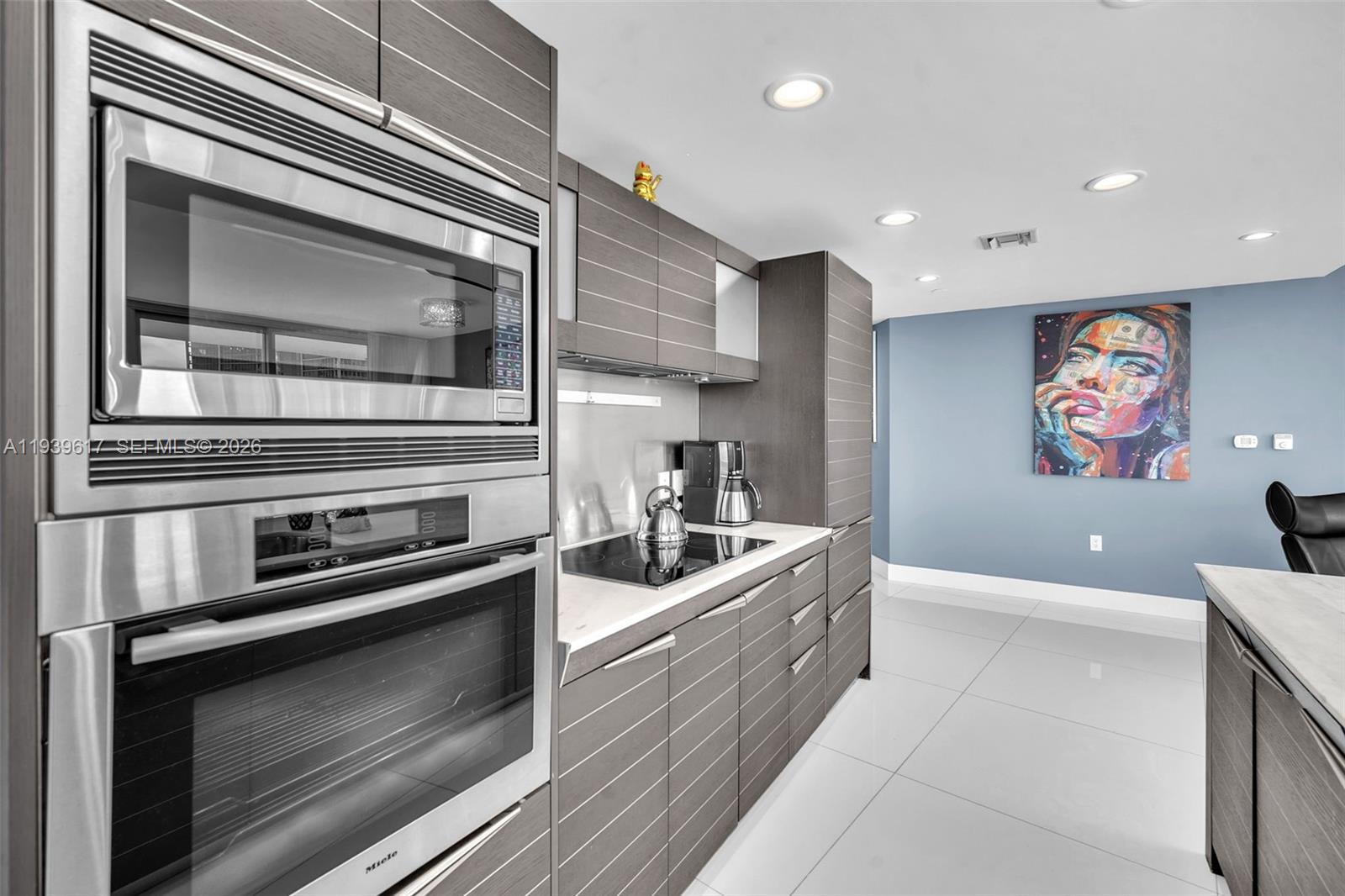 200 Biscayne Blvd Way, Unit 4202 Miami, FL 33131 - Photo 10 of 31 a kitchen with stainless steel appliances kitchen island granite countertop a stove and a microwave