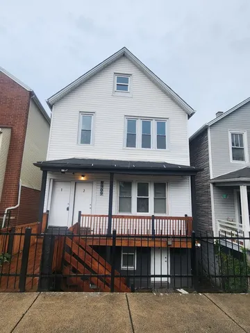 a view of a house with wooden deck