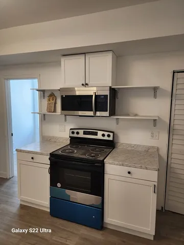 a kitchen with a stove and a microwave
