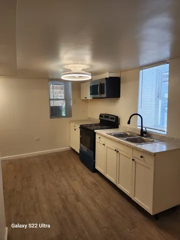 a kitchen with granite countertop a sink and cabinets