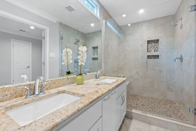 a bathroom with a granite countertop sink mirror and double