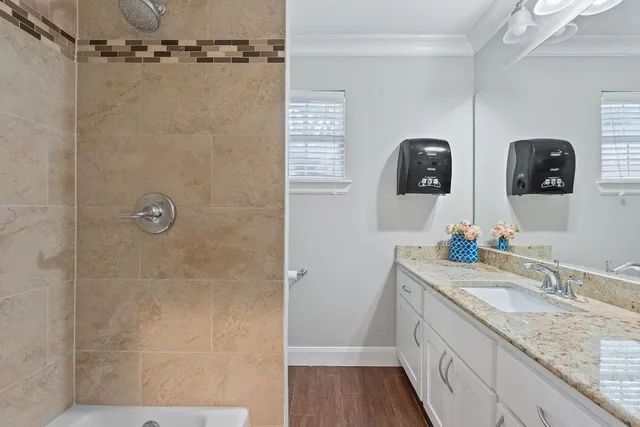a bathroom with double vanity and a mirror