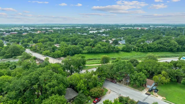 a view of a green field with lots of bushes