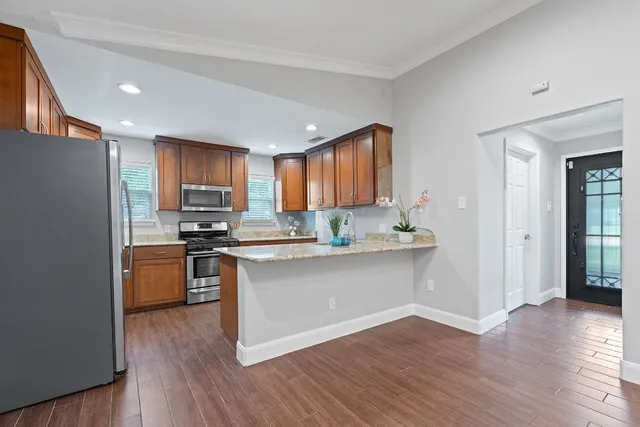 a view of kitchen with wooden floor and a window
