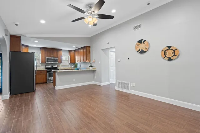 a view of kitchen with refrigerator microwave and stove