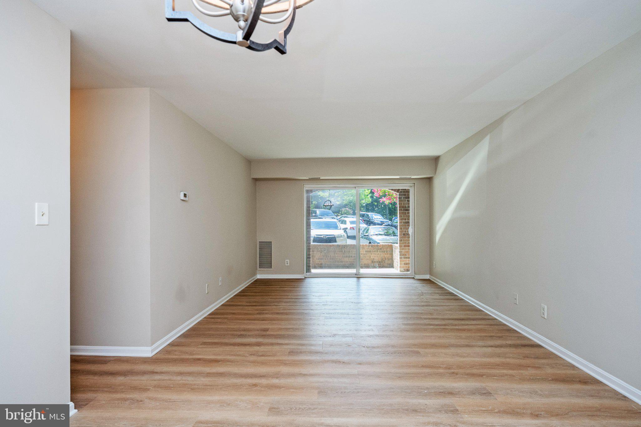 5908 Cove Landing Road, Unit 204 Burke, VA 22015 - Photo 7 of 32 Living room with glass doors to patio