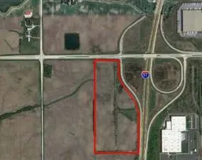 a view of a lush green field with a lake view