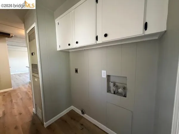 a view of storage and utility room with wooden floor