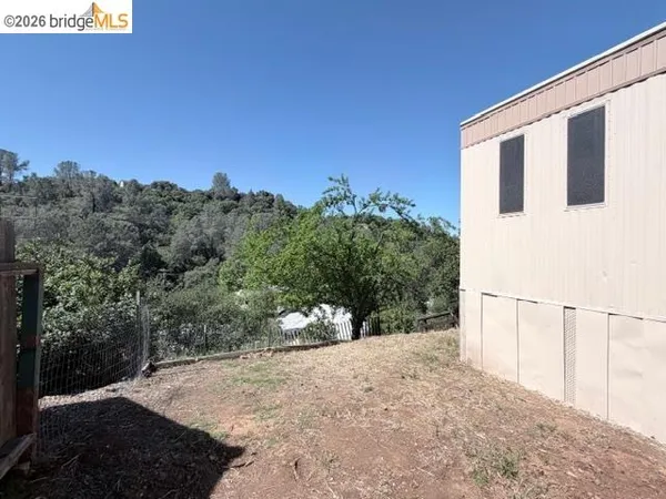 a view of a backyard of the house