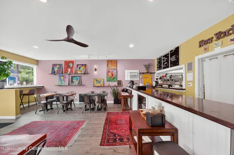 a very nice looking living room with furniture and kitchen view