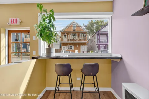 a living room with a table and a potted plant