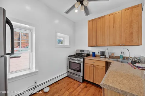 a kitchen with stainless steel appliances granite countertop a stove a sink dishwasher and a microwave oven with cabinets