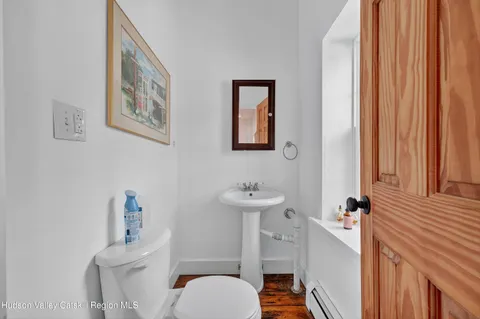 a bathroom with a sink a toilet and a mirror