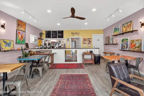 a living room with lots of furniture and kitchen view