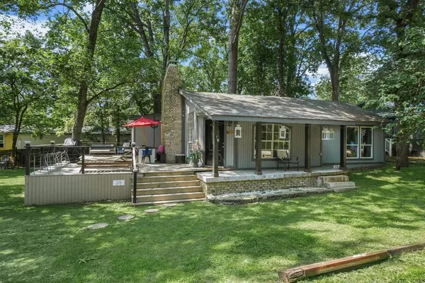 a view of a house with a yard and sitting area