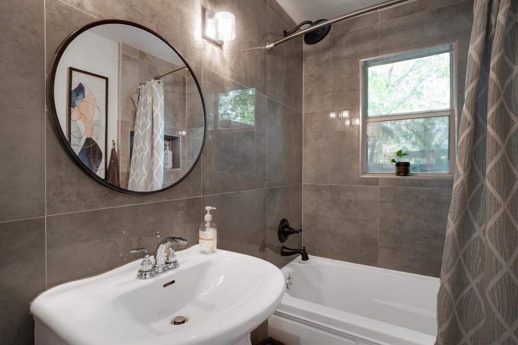 624 Apache Trail Tool, TX 75143 - Photo 16 of 21 a bathroom with a sink a mirror a bathtub and shower