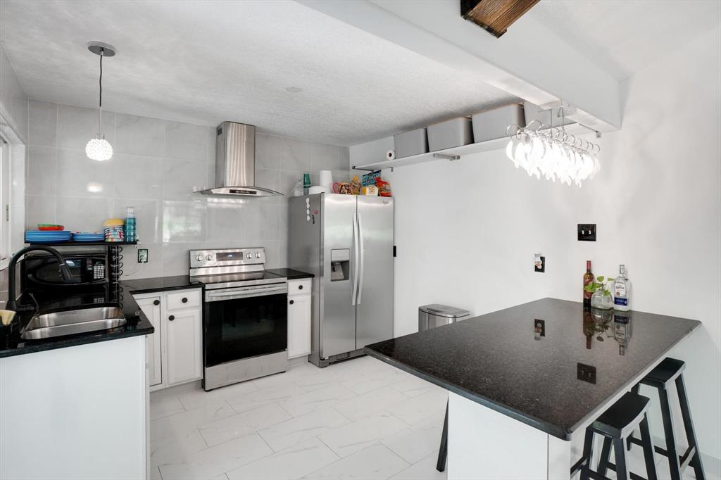 624 Apache Trail Tool, TX 75143 - Photo 3 of 21 a kitchen with a sink a stove and refrigerator