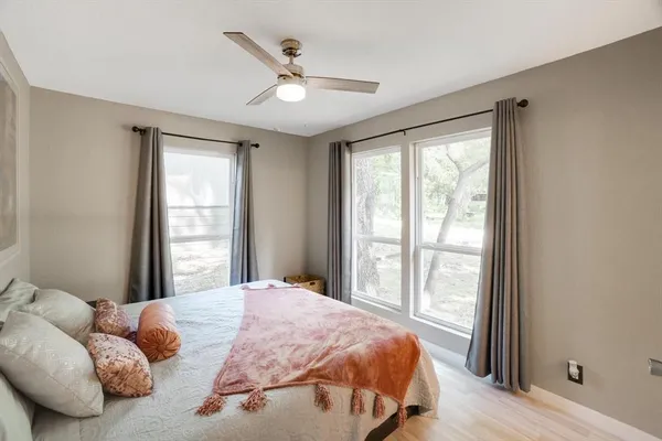 a bedroom with a large bed and a large window