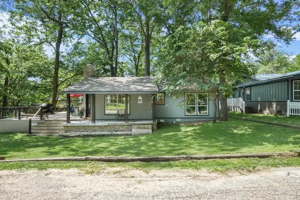 a view of house with backyard space and garden