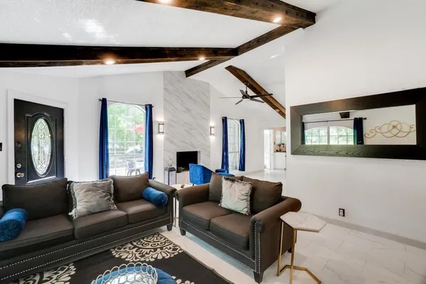 a living room with furniture and a flat screen tv