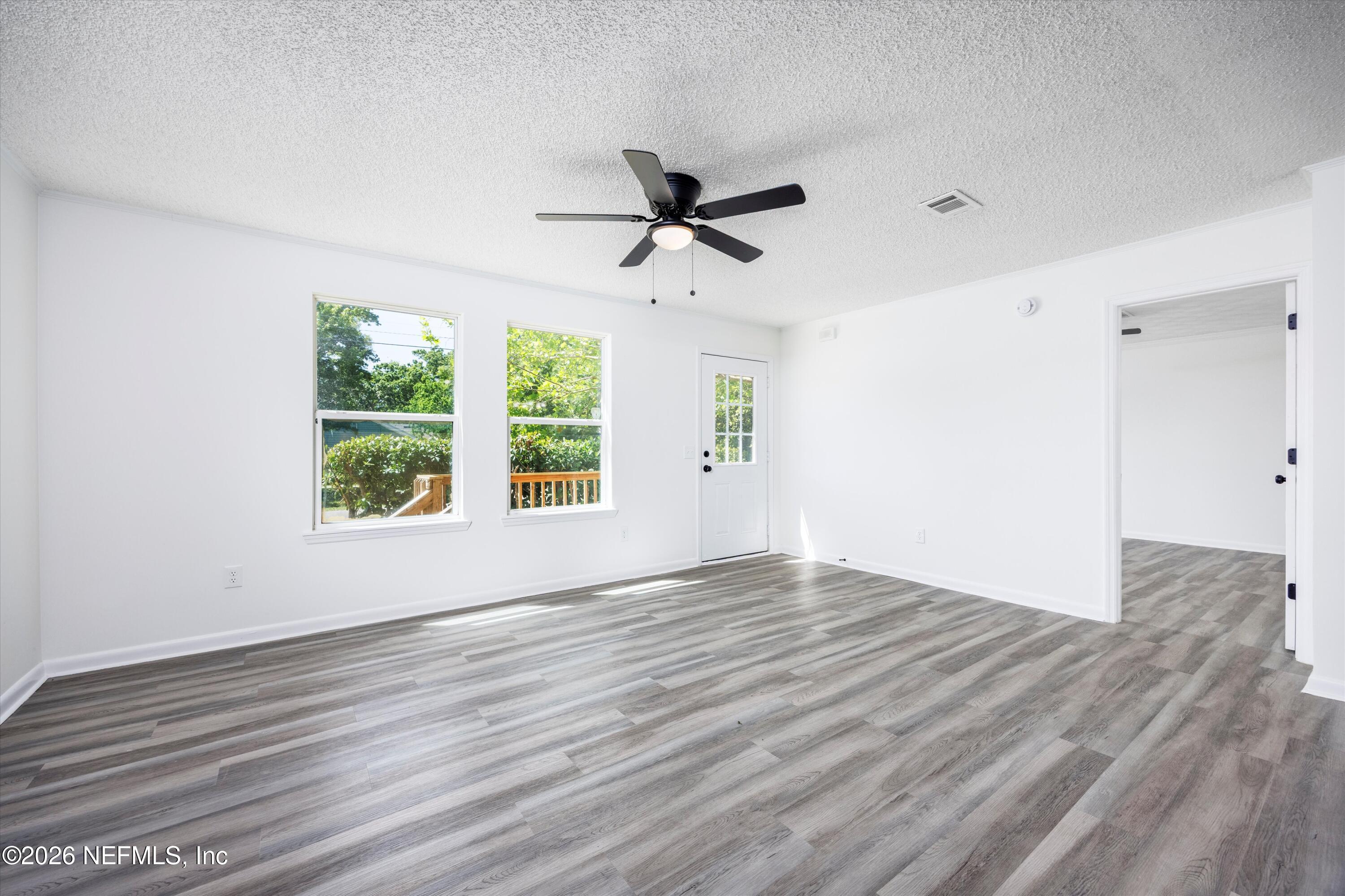 900 Helen Street St. Augustine, FL 32084 - Photo 6 of 31 wooden floor in an empty room with a window