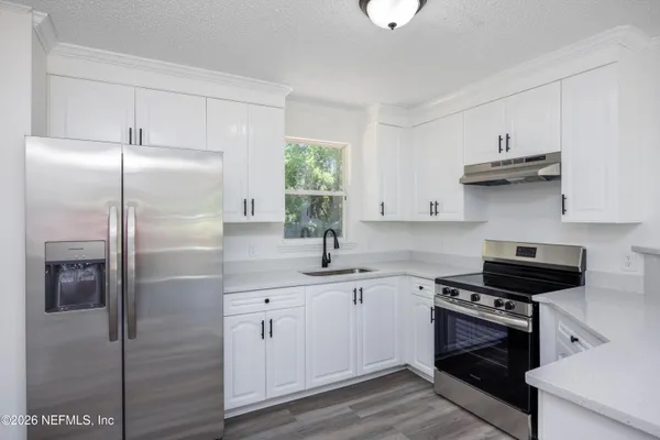 a kitchen with stainless steel appliances granite countertop a stove and a sink