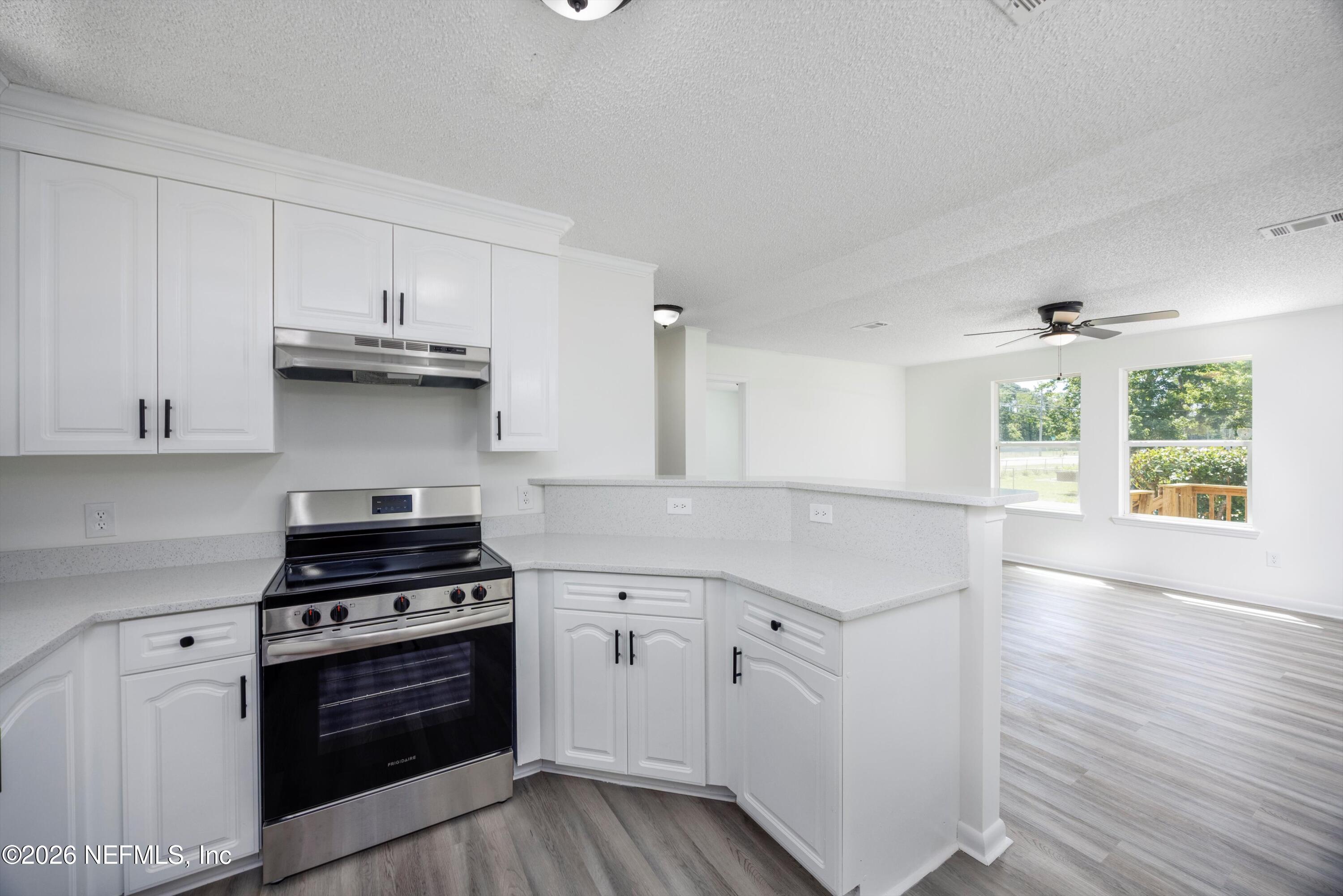 900 Helen Street St. Augustine, FL 32084 - Photo 10 of 31 a kitchen with granite countertop a stove and a sink