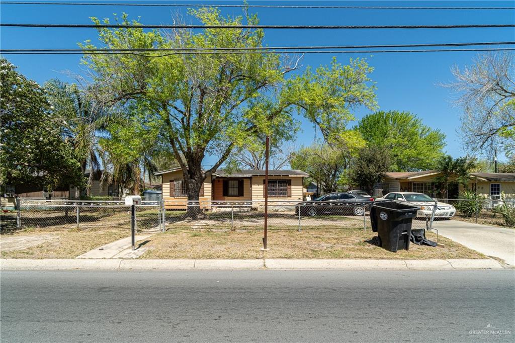 View of front of home with a fenced front yard and a gate
