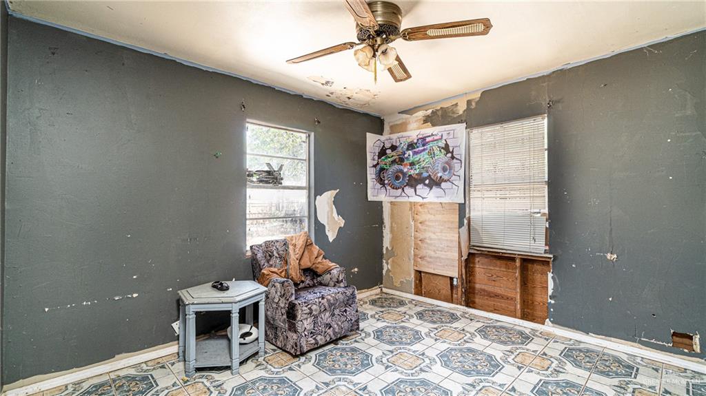 610 West Pike Boulevard Weslaco, TX 78596 - Photo 14 of 15 Sitting room with ceiling fan and light tile patterned flooring